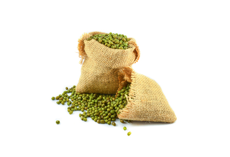 Mung beans in sack isolated on white backgroundの写真素材