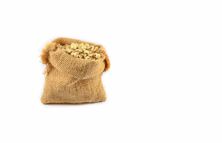 Job's tears coix lachryma jobi grain seeds in sack isolated on white backgroundの写真素材