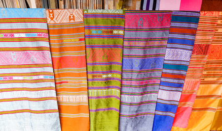 Traditional thai and Laos Sarong colorful on clothes line / woven silk shopの写真素材