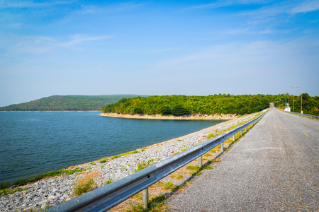 Road on dam or reservoir / Landscape river mountain and  blue sky backgroundの写真素材