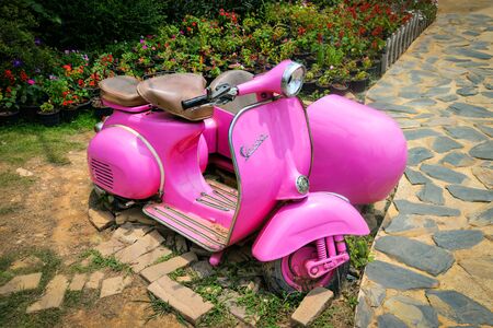 Bangkok Thailand 4 July 2017 : Old vintage Vespa pink stands in the flower garden park, Scooter Motorcycleのeditorial素材