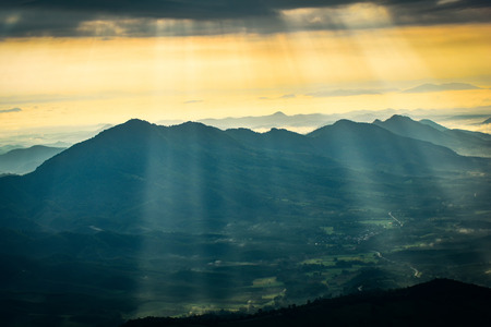 Wonderful landscape sunrise on hill mountain with rays of sunlight shining on the cloud sky amazing...