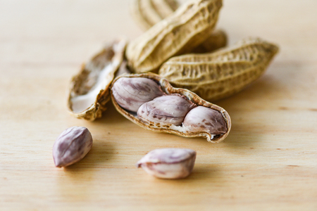 Peanut in shells and wooden background close up / Boiled peanuts