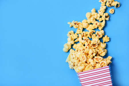 Popcorn cup box and blue backgroubd top view / Sweet butter popcorn saltの写真素材