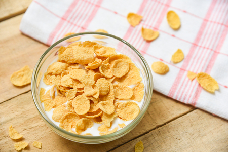Breakfast Cornflakes in bowl with milk on wooden background for cereal healthy food