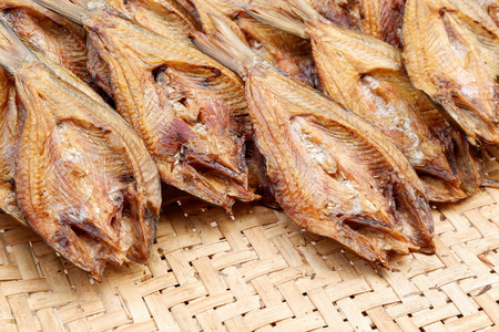 Making dried fish / dry salted fish on threshing basket backgroundの写真素材