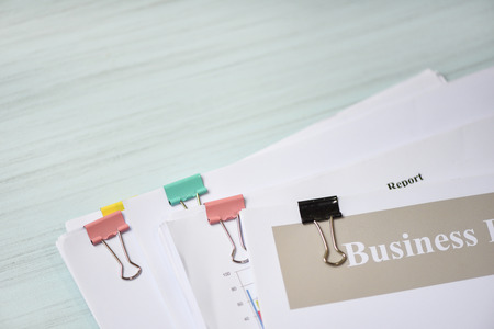 Report paper document present financial with paper clip and business report on office table backgroundの写真素材