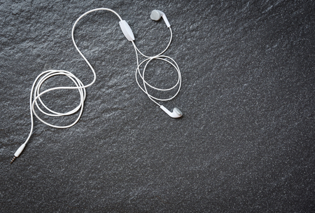 Earphons on dark background top view / Music is my life and entertainment listen to music conceptの写真素材