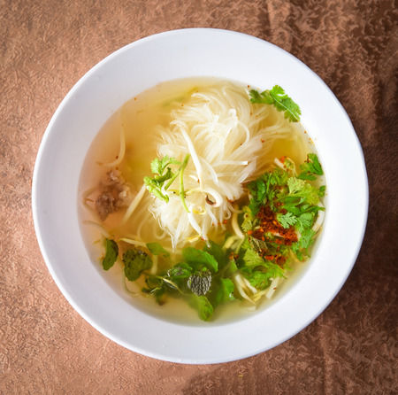 Noodle soup bowl Thai Laos Vietnam and Chinese with pork meat and vegetables asian style foodの写真素材