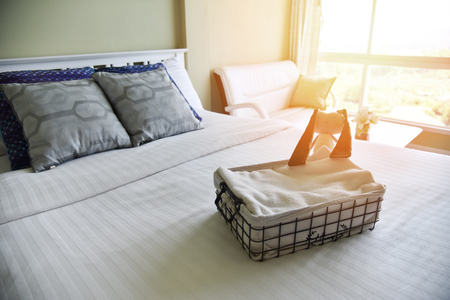 bedroom window in the morning room with Pillow and blankets cover on the bed / the sun shines through windowの写真素材