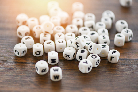 Text dice cube concept / Letter dices alphabet on wooden backgroundの写真素材