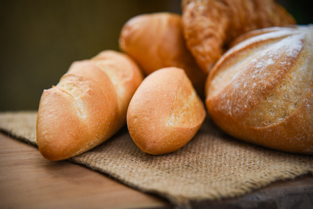 bread and buns assortment / Fresh Bakery bread various types on sack in the rustic table homemade...