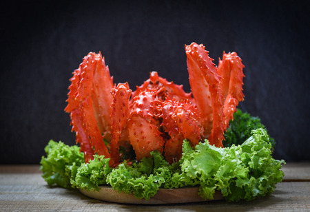 Alaskan King Crab Cooked steam or Boiled seafood and lettuce salad vegetable with dark background / red crab hokkaidoの写真素材