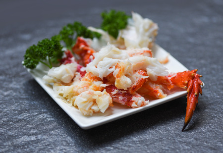 crab meat on white plate with spices for cooked seafood / red crab legsの写真素材