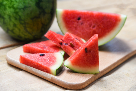 Fresh watermelon slice on wooden cutting board summer fruitの写真素材