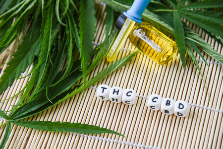 Cannabis oil in bottle products on wooden background - THC and CBD oil extract from cannabis leaf marijuana leaves for Hemp medical healthcare natural selective focusの写真素材