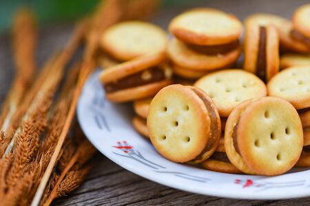 Homemade cookies with jam pineapple on wood table / biscuits cookies on plate for snack cracker