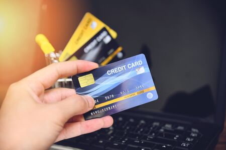 credit card and using laptop easy payment online shopping concept / electronic card in hand for pay onlineの写真素材
