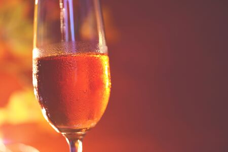 Champagne glass on table against blurred lights background / perspective of crystal clear wine glass for night party on the counter top bar restaurantの写真素材