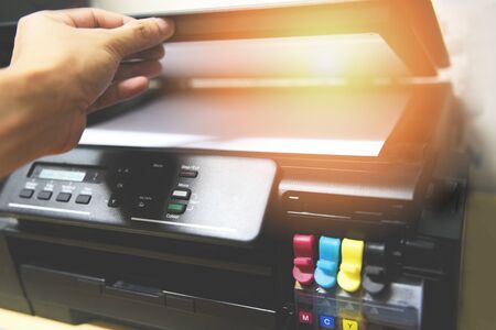 Copier concept / Business man hand open paper on printer ink for scanner copy machine supplies at...