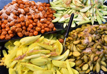 Asia fruit preserve on tray with star gooseberry, mango, Garcinia schomburgkiana pierre and jujube fruit for sale in street food thailandの写真素材