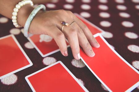 Tarot cards reading divination / Psychic readings and clairvoyance fortune teller hands conceptの写真素材