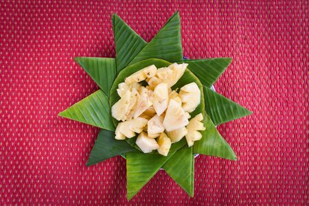 pineapple slice on banana leaf background summer fruit