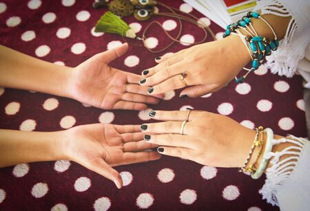 Fortune teller reading fortune lines on hand Palmistry Psychic readings and clairvoyance hands concept with Tarot cards divinationの写真素材
