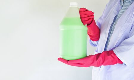 bottle liquid to clean dust on the floor , disinfectant floor cleaner solution for mop / woman maid hold the bottle of  bathroom cleaning liquidの写真素材
