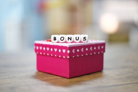 Yearly Bonus concept / Gift Box surprise for Encouragement Morale in table officeの写真素材