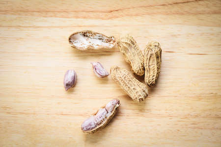 Peanut on wood background / Boiled peanuts peeledの写真素材