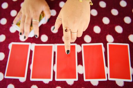 Tarot cards reading divination / Psychic readings and clairvoyance fortune teller hands conceptの写真素材