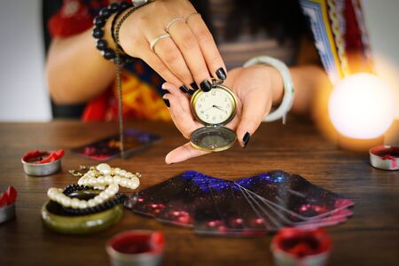 Psychic readings and clairvoyance concept / Crystal ball fortune teller with hands hold retro pocket...