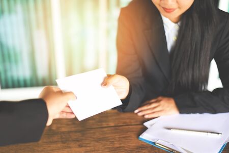 Asian business woman receiving salary bonus money from boss or manager at office happily / Yearly Bonus concept for encouragement moraleの写真素材
