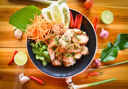 Grilled Pork Salad Thai food served on table with herbs and spices ingredients / Tradition northeast food Isaan delicious with fresh vegetables - Hot and Spicy Slice grilled pork menu Asian foodの写真素材