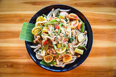 Papaya salad mix noodle vegetable and peanut served on dining table / rice noodle salad spicy thai food on plate with herbs and spices ingredients - Som tum Thai menu Asian foodの写真素材