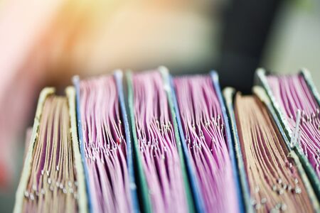 Documents in files placed in the filing cabinet with paper clip / business paper document file sort in a office deskの写真素材