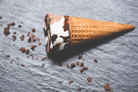 ice cream cone chocolate vanilla on the dark background / ice cream scoops  chocolate chunks and sweet dessertの写真素材