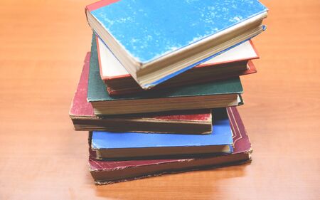 Old books on a wooden table / Open book stack in the library room for business and education wall background , back to school conceptの写真素材