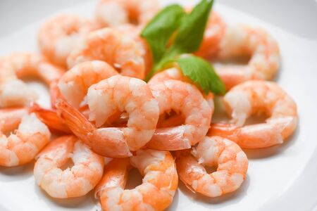fresh shrimps served on plate / boiled peeled shrimp prawns cooked in the seafood restaurantの写真素材