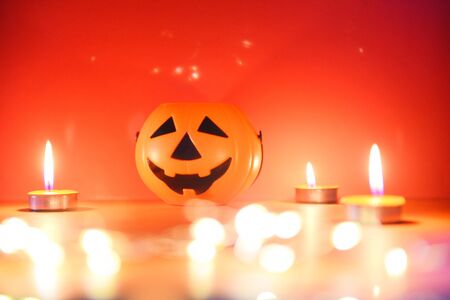 Halloween background candlelight orange decorated holidays festive concept / funny faces jack o lantern pumpkin halloween decorations for party accessories object with candle light bokehの写真素材