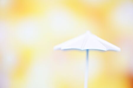 Close up white umbrella on bokeh and yellow blur background , selective focusの写真素材