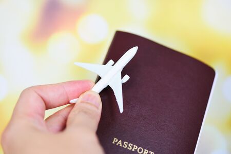 airplane and passport in hand flight travel traveller fly travelling citizenship air boarding pass travel business trip on blur backgroundの写真素材