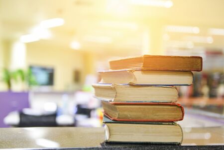 Old books on a wooden table / Open book stack in the library room for business and education background , back to school conceptの写真素材