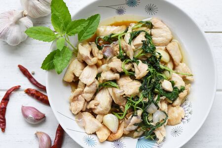 Basil chicken fillet with garlic chilli Spicy Thai food / Stir fried chicken with holy basil on plateの写真素材
