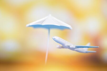 Insurance travel concept / Air travelling and white umbrella on airplane flying over the sunset blur backgroundの写真素材