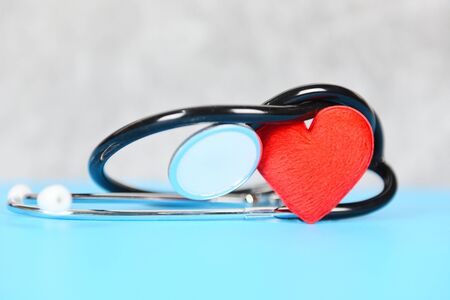 Insurance Health concept / Stethoscope and red heart healthcare on blue background