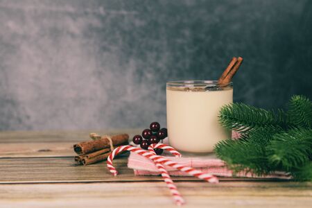 Eggnog delicious holiday drinks like themed parties with cinnamon and nutmeg for Traditional Christmas and winter holidays Homemade eggnog in glasses and fresh eggs decorated on the tableの写真素材