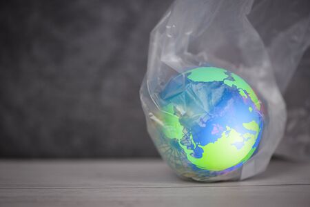 Plastic world or World Environment Day Concept / The planet earth in a plastic bag ban say no...