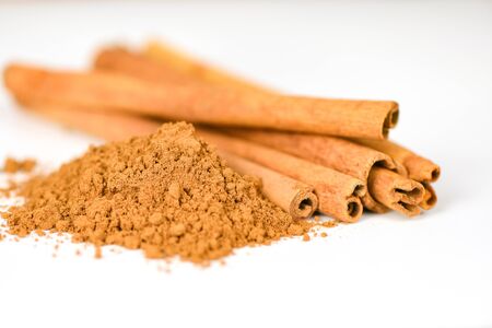Cinnamon sticks and cinnamon powder herbs and spices on white background